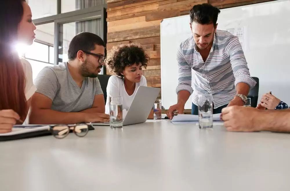 Business people round a table